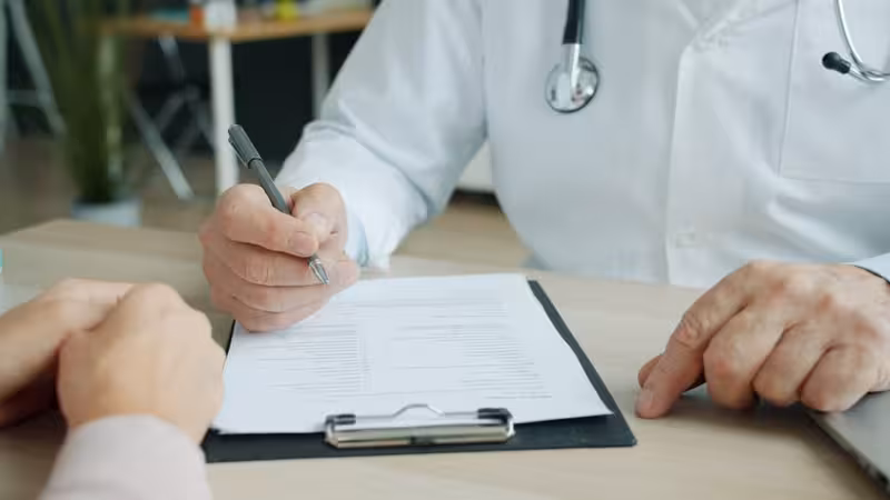 Microsuction Vs. Ear Syringing: A doctor and patient during a consultation Doctor and patient consultation for Microsuction Vs. Ear Syringing - How Busy Is Enfield: Private Microsuction Ear Wax Remov...